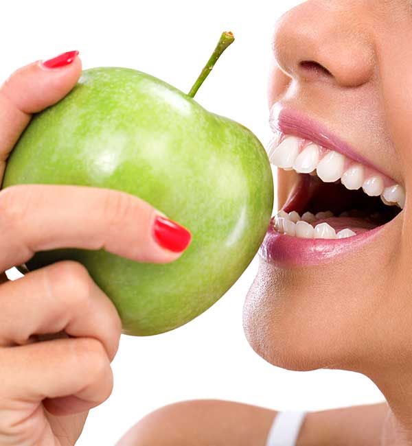 Frau beisst in Apfel